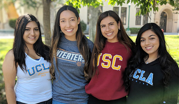 Students with apparel of universities they are transferring to